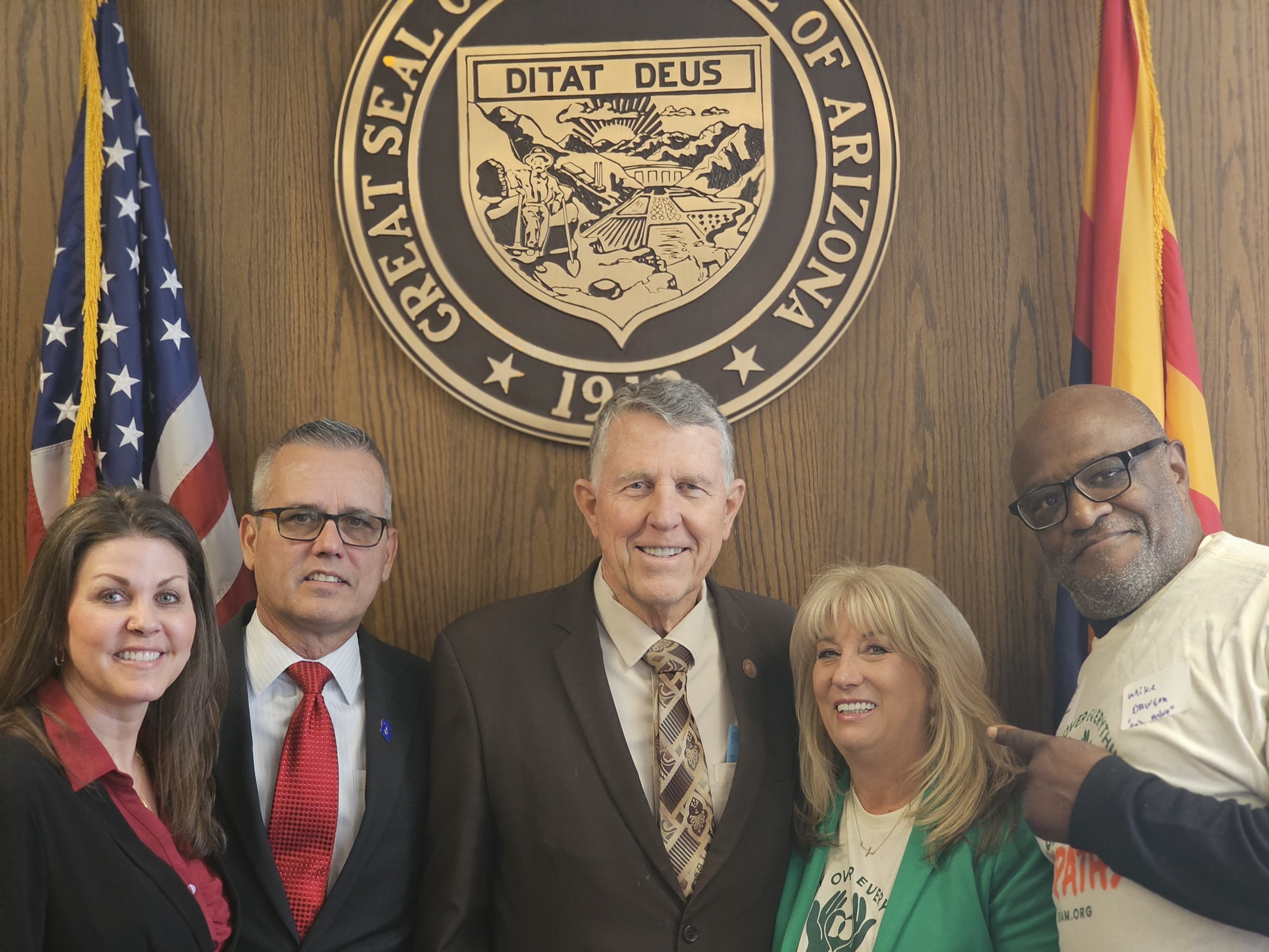 Advocates and legislators together beneath the Great Seal of Arizona